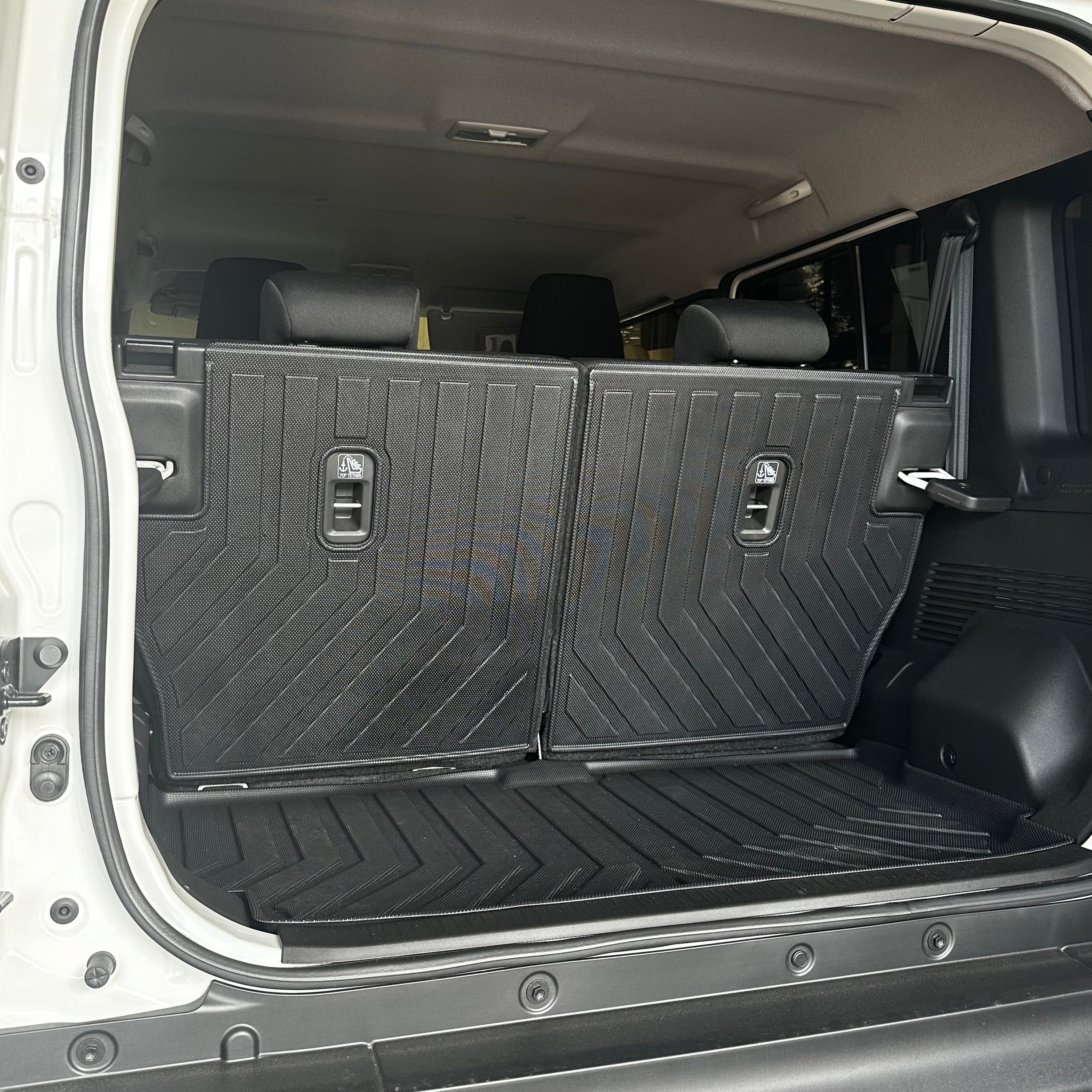 2nd row rear mats placed inside a vehicle's cargo area,